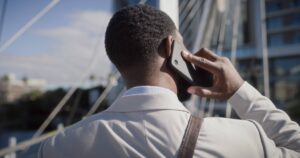 a gentleman on the phone in a business suit to symbolize he is in contact with someone for work